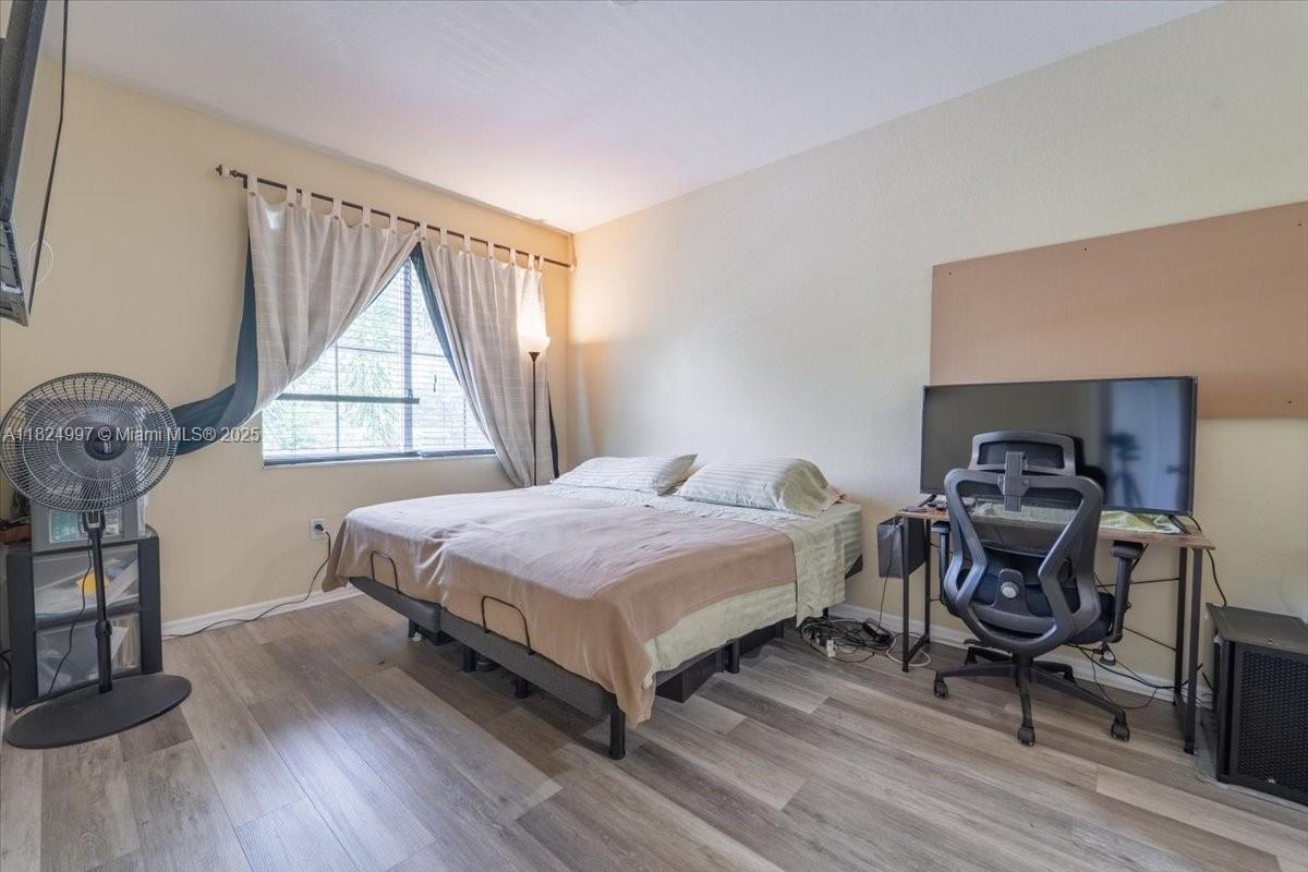 370 Lake Monterey Circle Boynton Beach, FL 33426 - Photo 14 of 17 a bedroom with a bed and a window