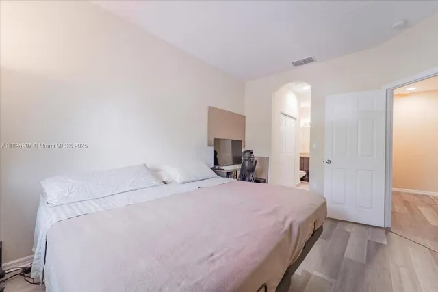 a bedroom with a bed and a mirror