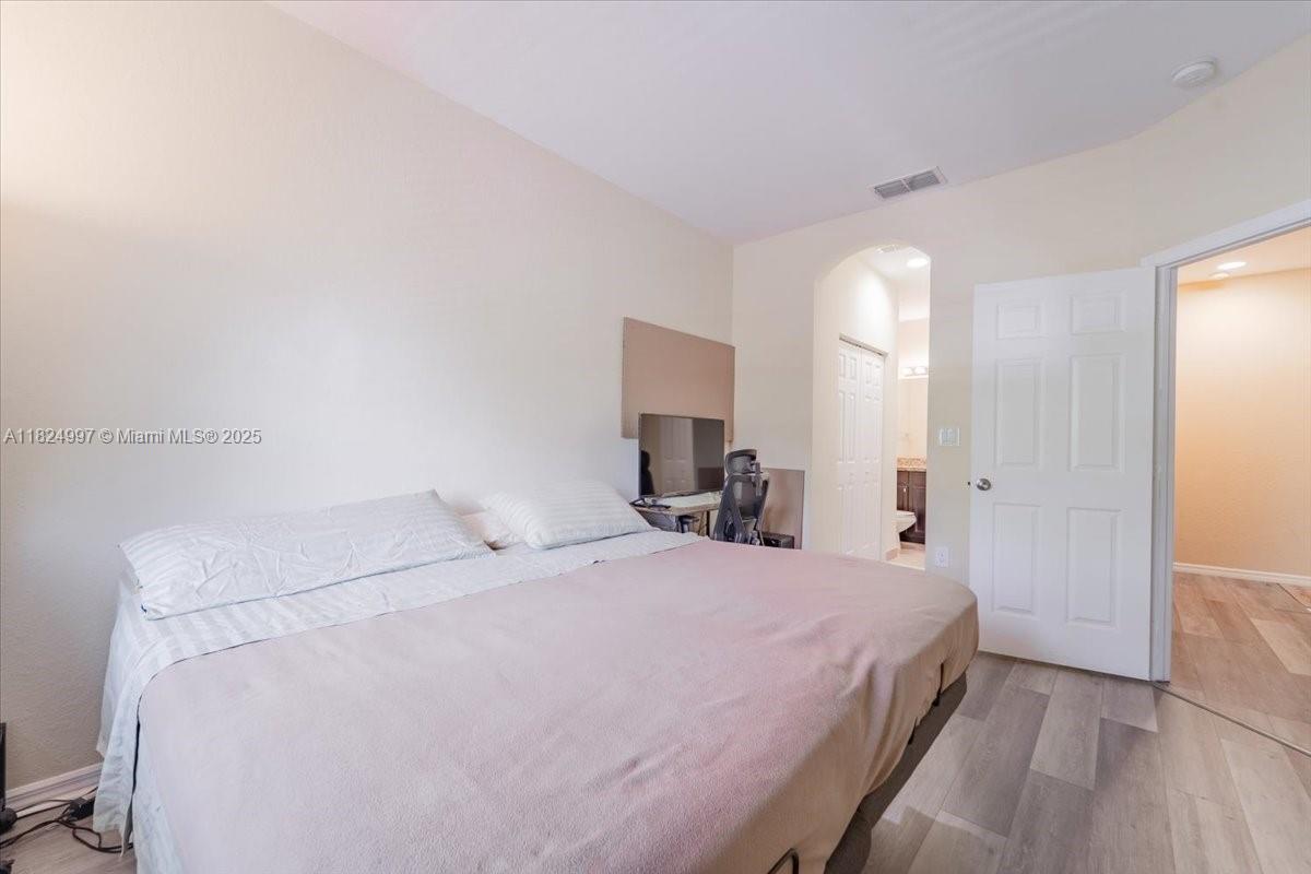 370 Lake Monterey Circle Boynton Beach, FL 33426 - Photo 15 of 17 a bedroom with a bed and a mirror