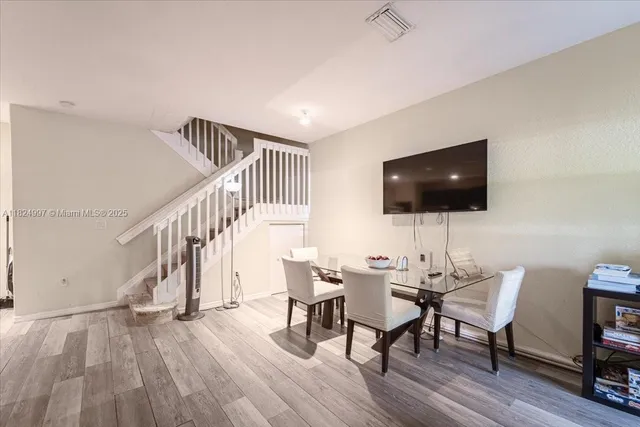 a view of a livingroom with furniture and a flat screen tv