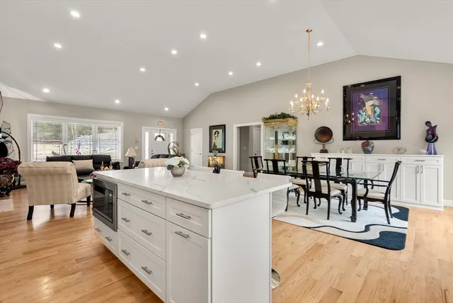 a bedroom with a bed and a dresser next to a window