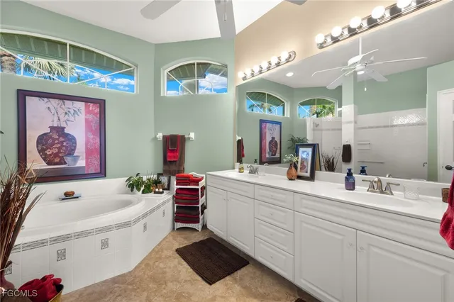 a bathroom with a sink a vanity a mirror and a bathtub