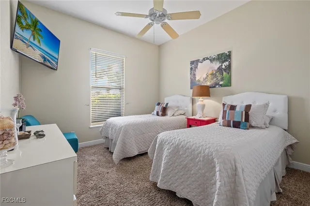 a bedroom with two beds and a chandelier