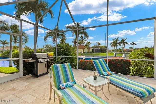 a balcony with chairs and a potted plant
