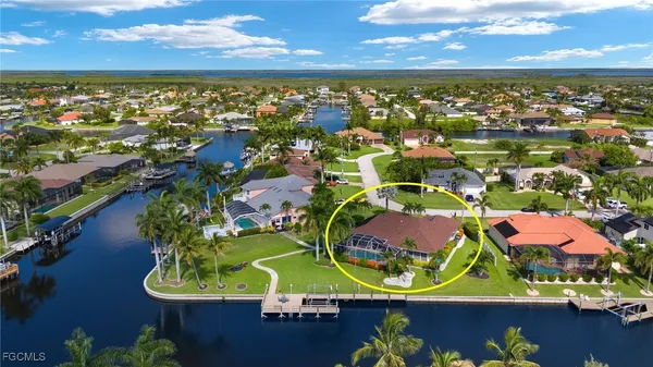 an aerial view of residential houses with outdoor space and lake view