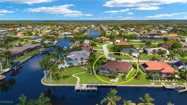an aerial view of residential houses with outdoor space and lake view