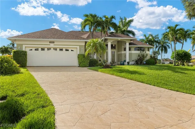 a dining room with furniture a chandelier and wooden floor