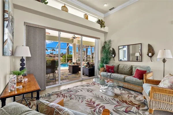 a living room with furniture a rug and white walls