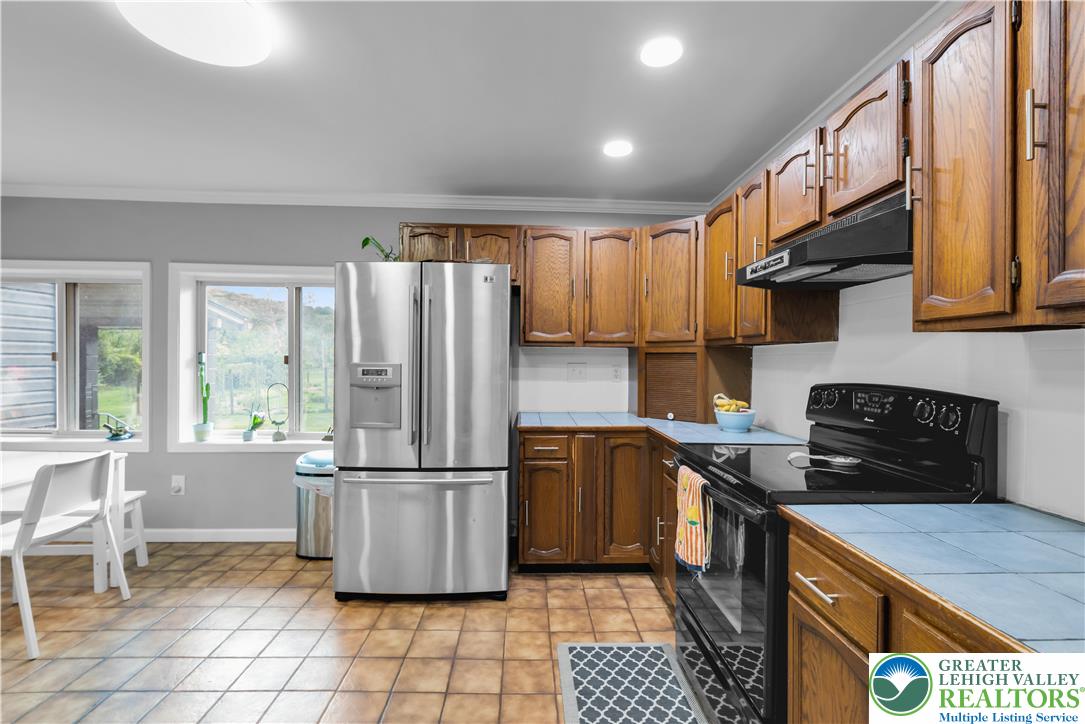 2242 Church Road Bethlehem, PA 18015 - Photo 16 of 74 a kitchen with stainless steel appliances granite countertop a refrigerator a sink a stove a microwave and island