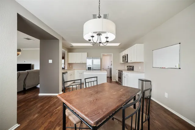 a view of a dining room with furniture and wooden floor