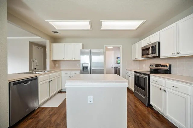 a kitchen with a sink stove and refrigerator