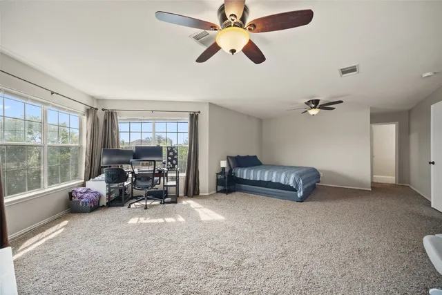 a bedroom with furniture and a large window