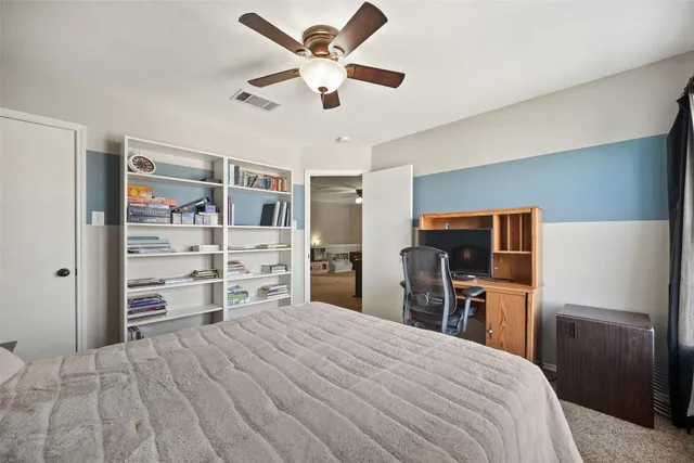 a bedroom with a bed and a television