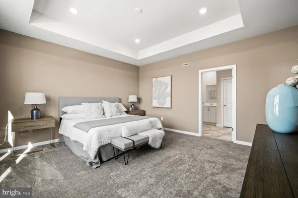 a spacious bedroom with a bed and a couch