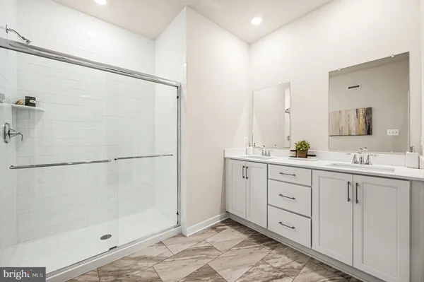 a bathroom with a double vanity sink and mirror