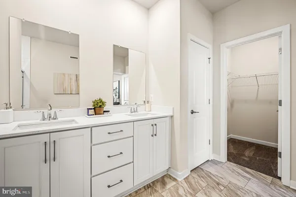 a bathroom with a double vanity sink and mirror
