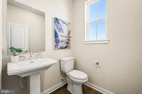a bathroom with a sink mirror and toilet