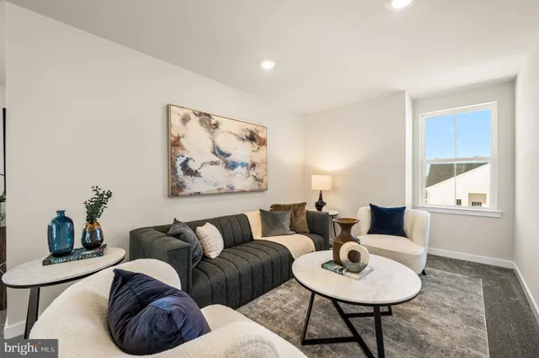 a living room with furniture a rug and a table