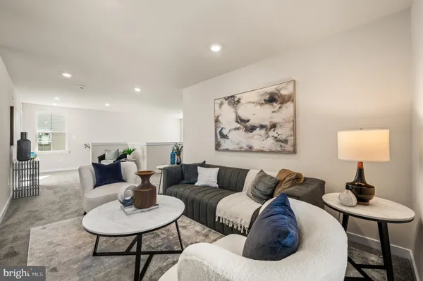 a living room with furniture and a lamp