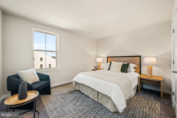 a bedroom with a bed wooden couch and a window