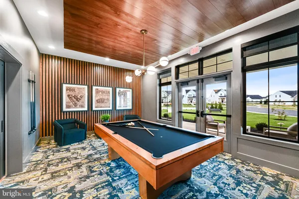 swimming pool view with a seating space