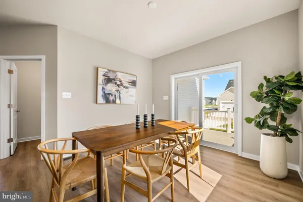 a dining room with furniture and wooden floor