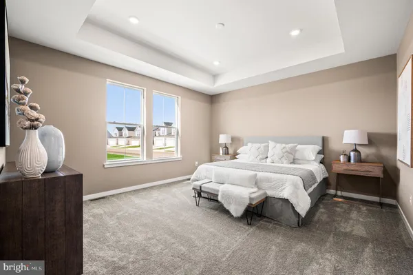 a spacious bedroom with a bed and a window