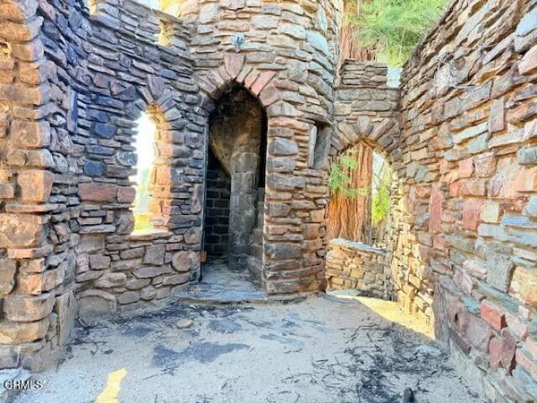 a view of empty room with a fireplace and chandelier