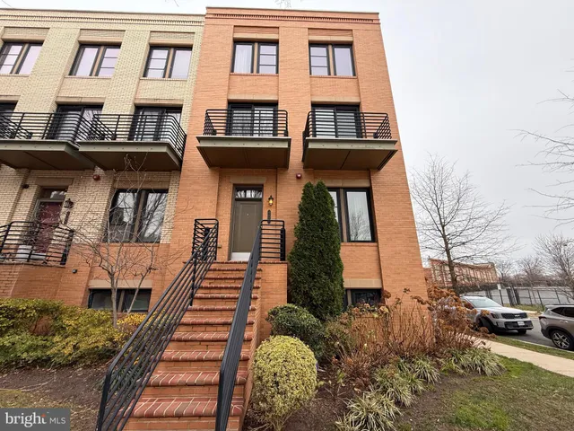 a view of a brick house with many windows