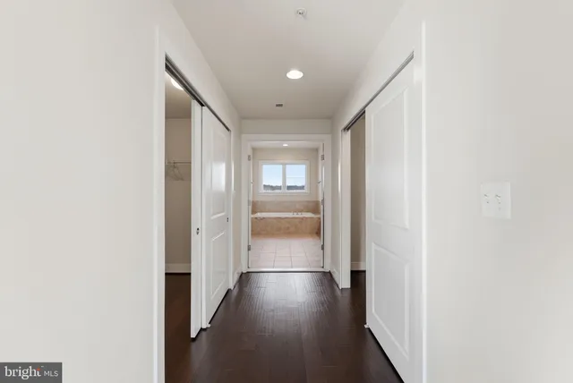 a view of hallway with wooden floor
