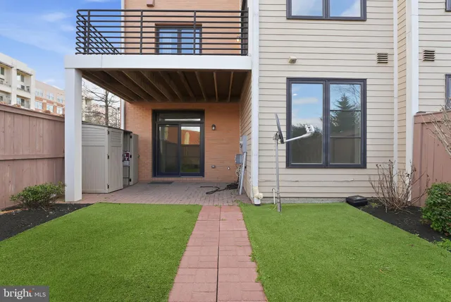 a front view of a house with a garden and plants