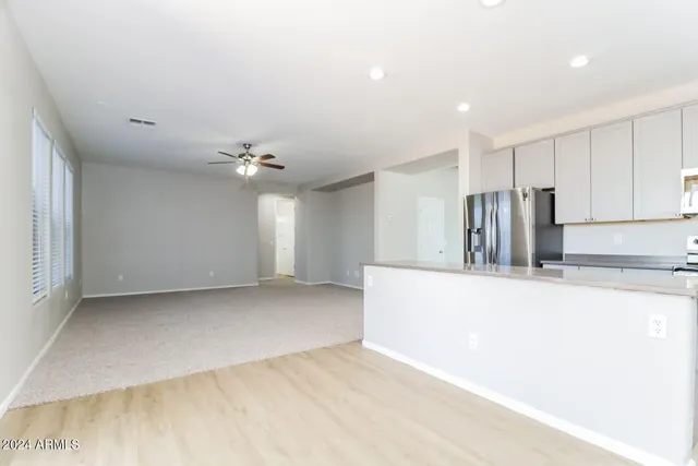 a view of kitchen with refrigerator and window