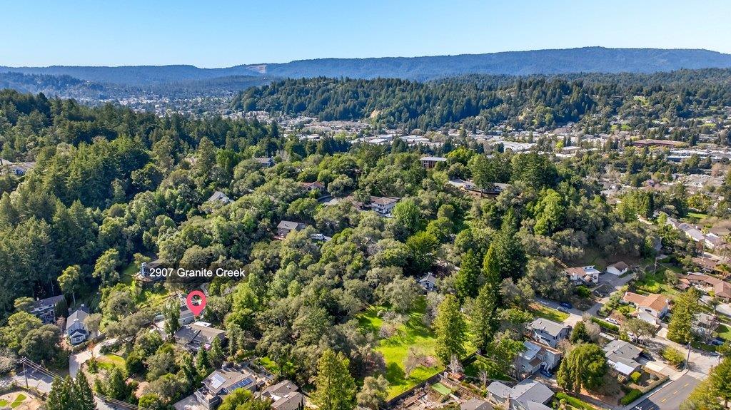 2907 Granite Creek Road Scotts Valley, CA 95066 - Photo 7 of 68 a view of a lush green field with mountains in the background