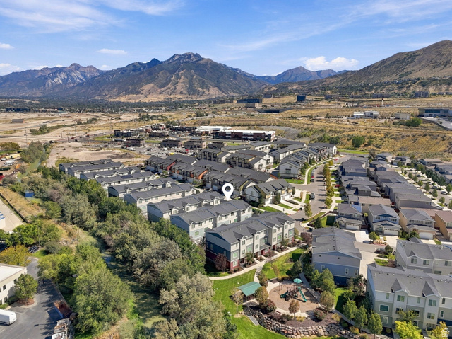 14764 Rising Star Way Riverton, UT 84065 - Photo 42 of 42 Townhome community with mountain backdrop, nearby playground, and mature trees