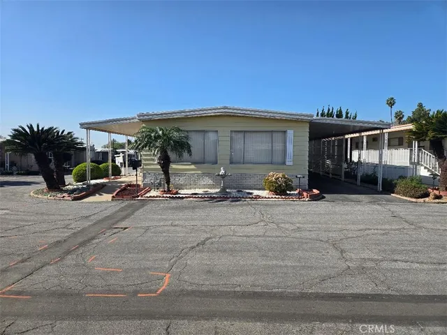 a front view of a house with cars parked
