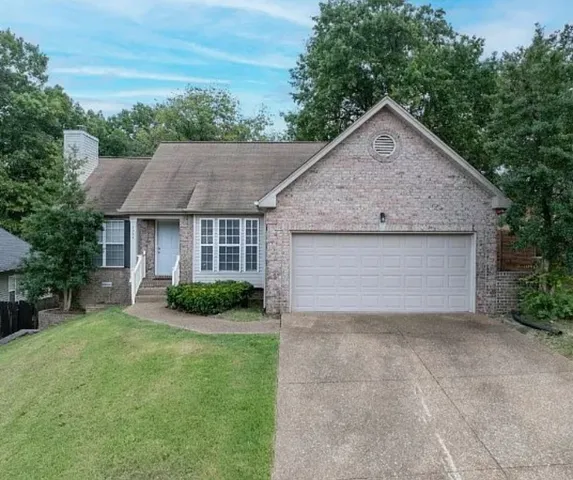 a aerial view of a house with yard and green space