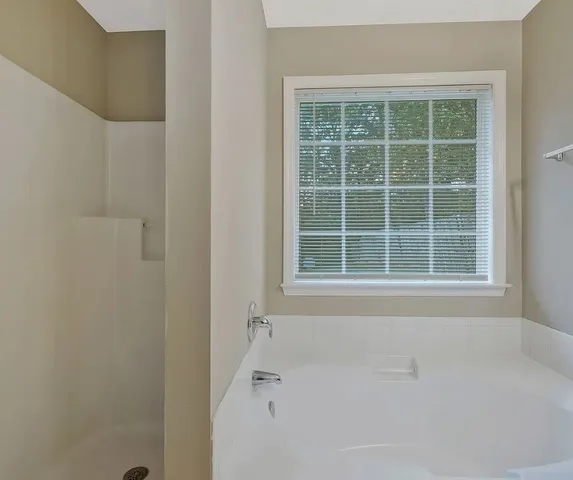a white bath tub sitting next to a window