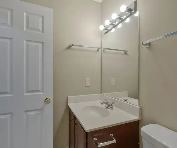 a bathroom with a sink vanity and a mirror