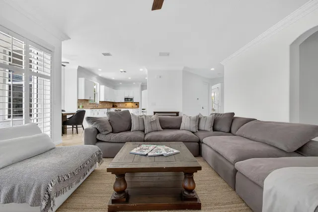 a living room with stainless steel appliances kitchen island furniture and a table