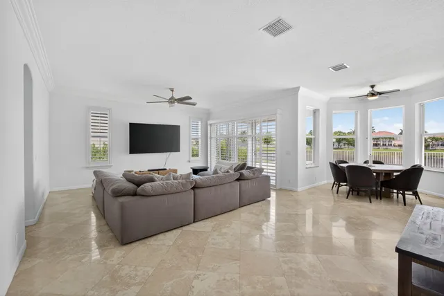 a large kitchen with stainless steel appliances kitchen island granite countertop a refrigerator and a sink