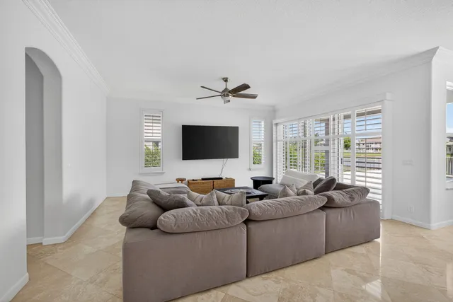 a kitchen with stainless steel appliances granite countertop a refrigerator a stove a sink a dining table and chairs