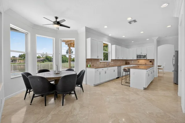a kitchen with stainless steel appliances granite countertop a refrigerator and a sink