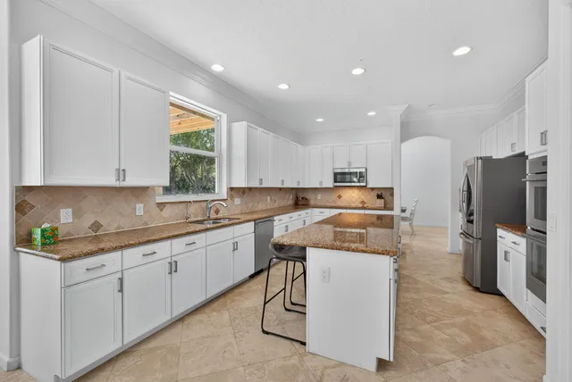 a view of swimming pool with outdoor seating and plants