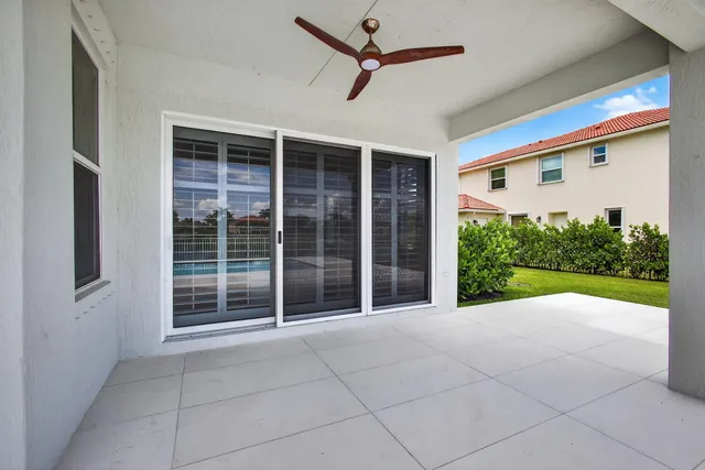 a bedroom with a bed and with a lamp on dresser