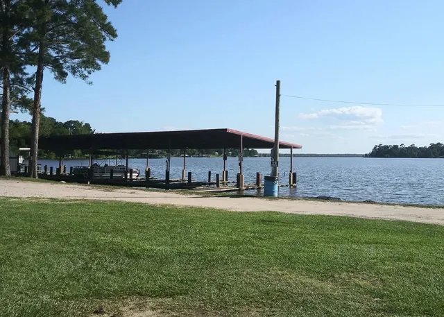 a swimming pool with outdoor seating and yard