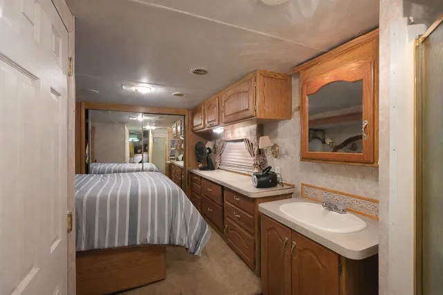a en suite bathroom with a sink double vanity and a mirror