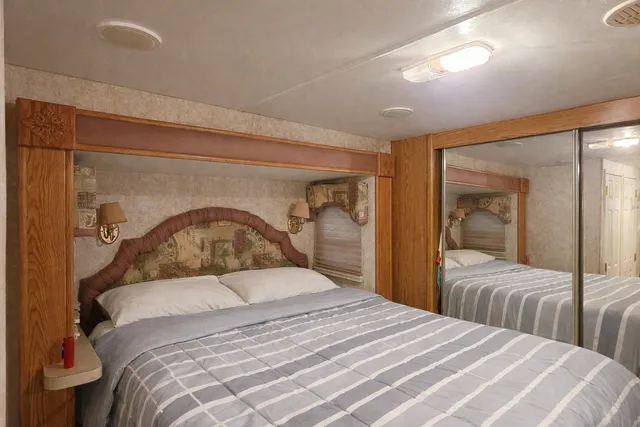 a bedroom with a large bed and a mirror