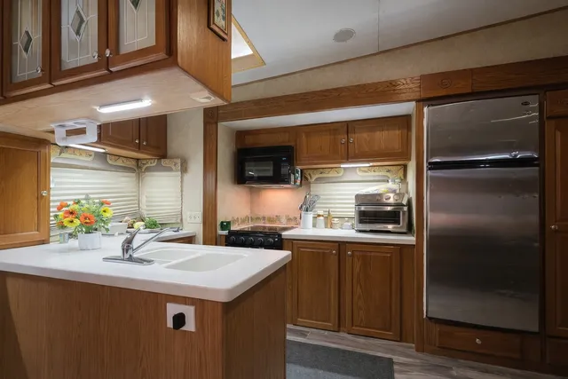 a kitchen with a sink stainless steel appliances and cabinets
