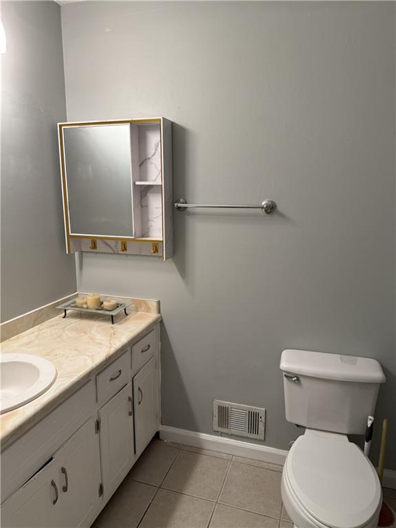 975 Ridgedale Drive Lawrenceville, GA 30043 - Photo 15 of 31 a bathroom with a granite countertop toilet sink and mirror