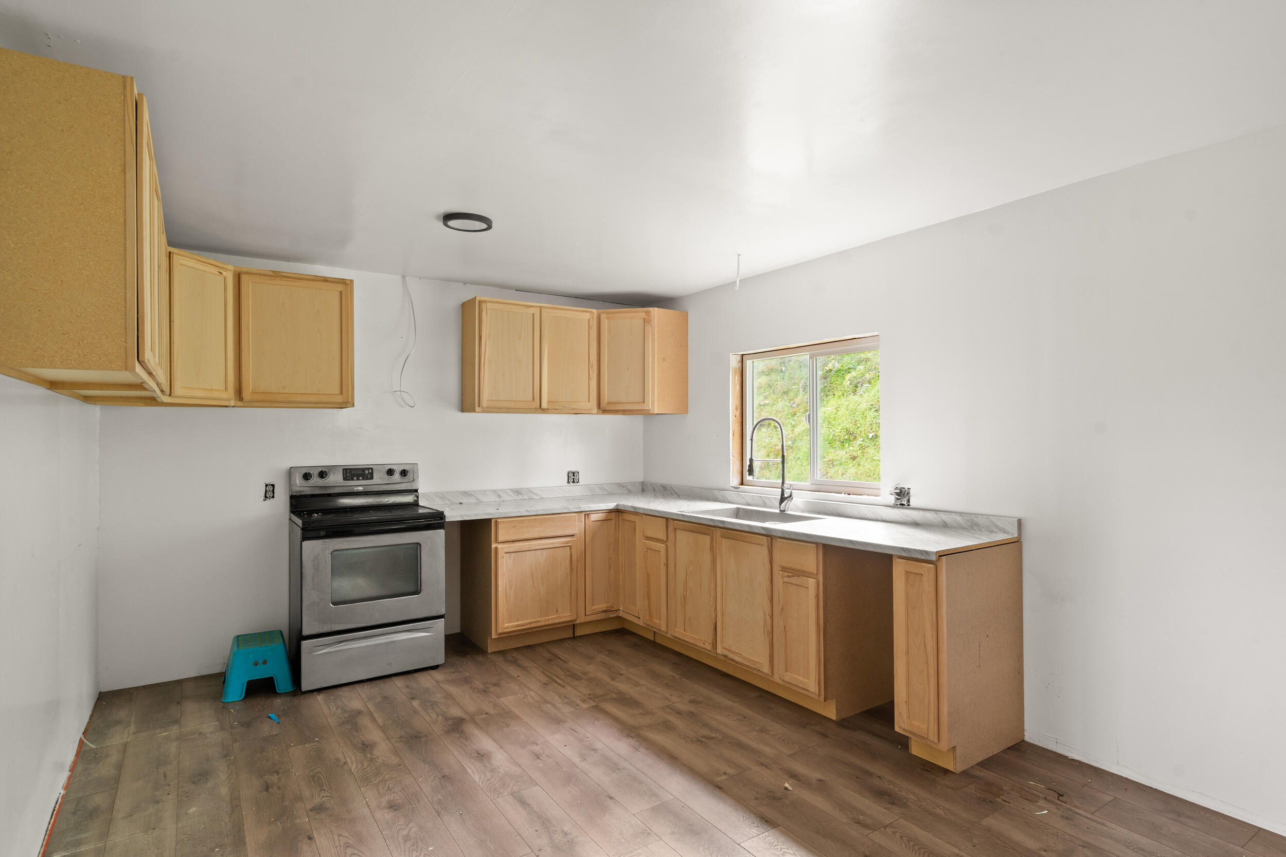 2373 Pioneer Road Talent, OR 97540 - Photo 14 of 28 a kitchen with stainless steel appliances granite countertop a stove a sink and a microwave